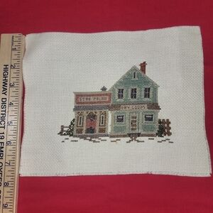 Cross-stitch village handmade. Just needs frame.